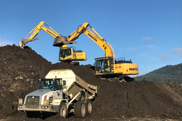 A construction site featuring heavy machinery in action.
