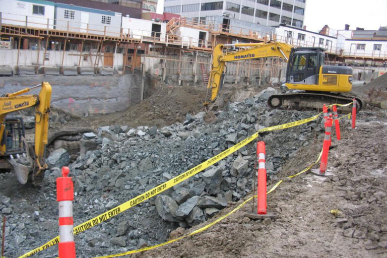 Machines work at a construction site.