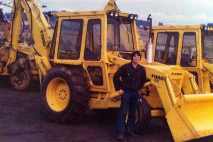 A photo of a Michell team member posing in front of equipment.